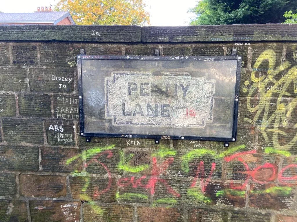 Inspiration for the song Penny Lane surrounds you as you drive down the road. Look closely at this sign, and you might see the Paul McCartney autograph. The famous Penny Lane street sign autographed by Paul McCartney, a highlight of the fab-four-liverpool-beatles experience.