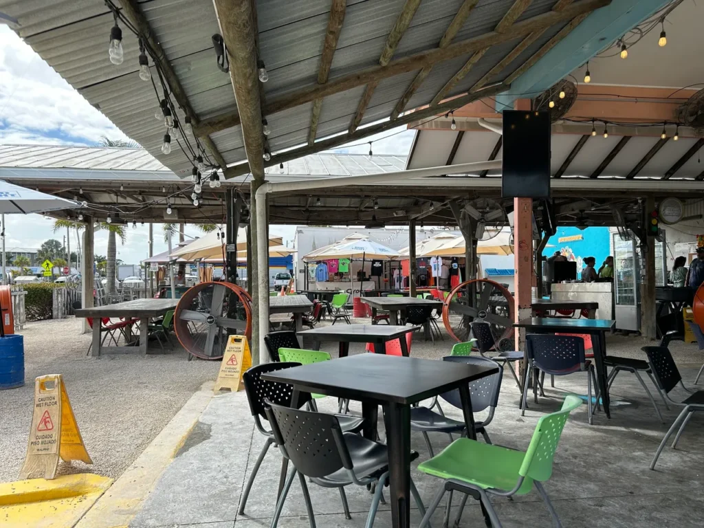 The expansive all-outdoor dining area and stage at the Ugly Grouper on Anna Maria Island, highlighted in our sarasota-bradenton-restaurants guide.