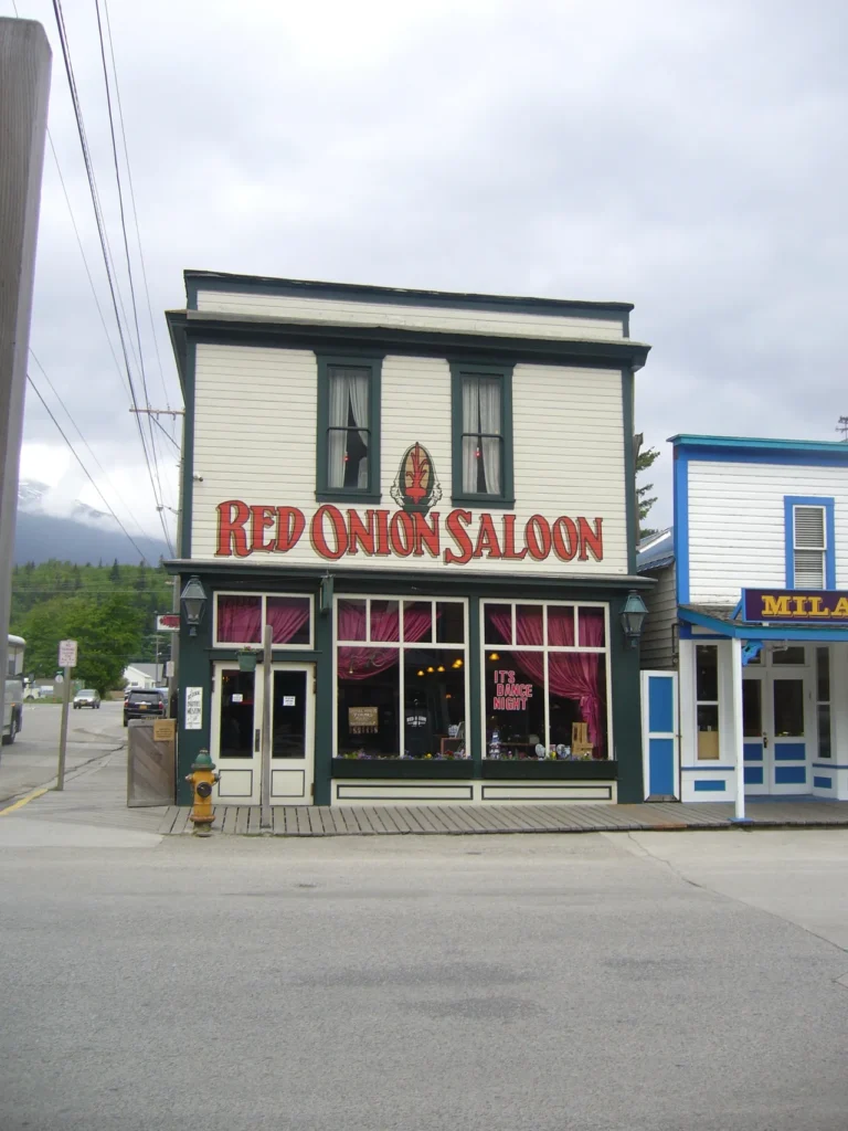 The historic exterior of the Red Onion Saloon along the wooden sidewalks on an alaskan-cruise-adventure.