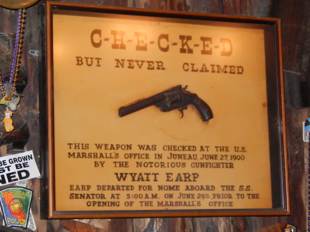 The historic "Checked But Never Claimed" Wyatt Earp gun display case inside the Red Dog Saloon on an alaskan-cruise-adventure.
