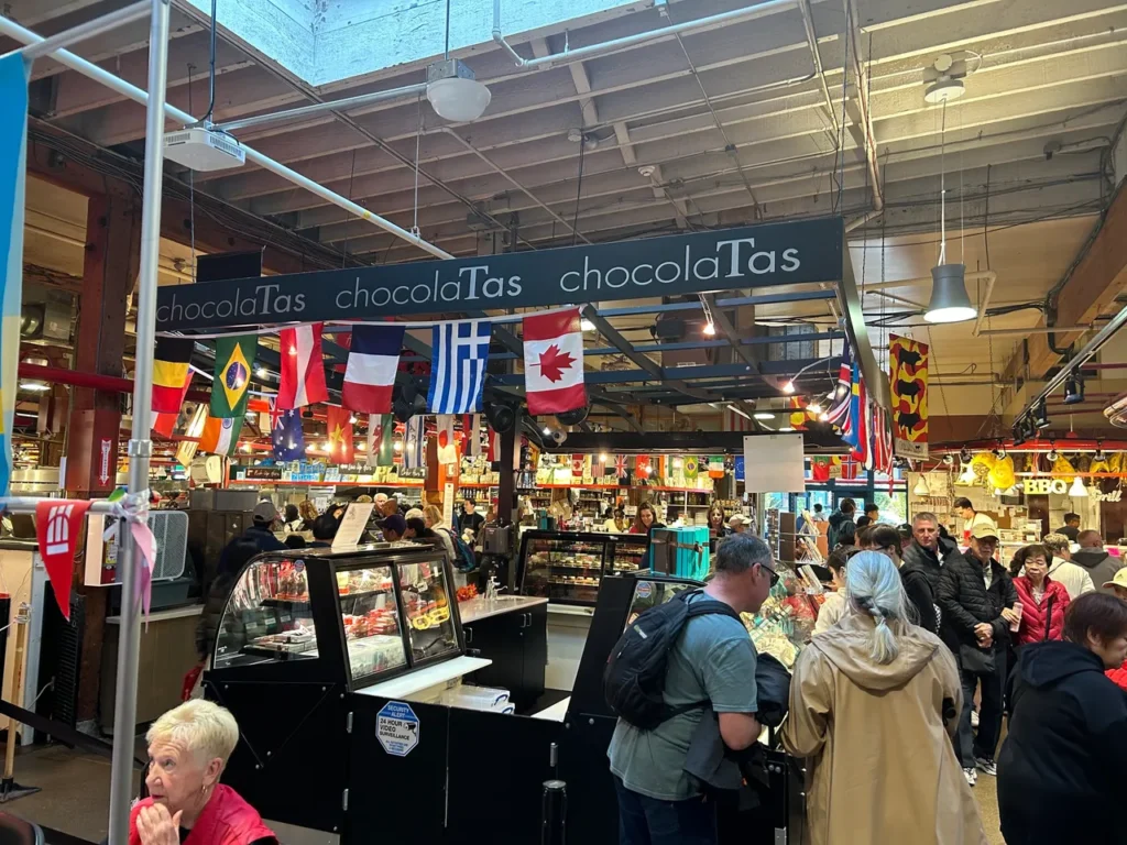 Started by a former auto mechanic, ChocolaTos serves up some amazing treats. Fine Belgian chocolate confections arranged inside the ChocolaTas shop counter on a Granville Market food tour Vancouver.