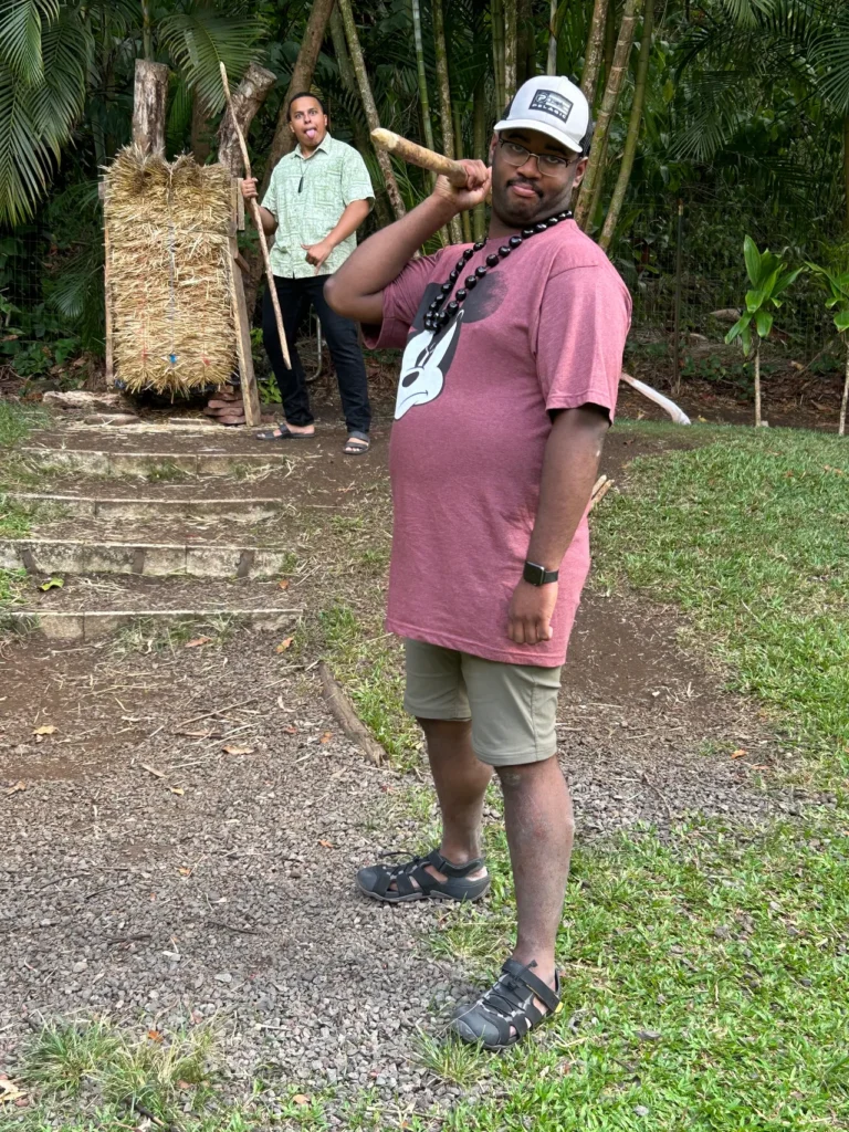 Spear throwing is one of the many activities you can experience without a long line to wait in. A guest trying out the traditional spear throwing activity station at the Nutridge Luau Honolulu.