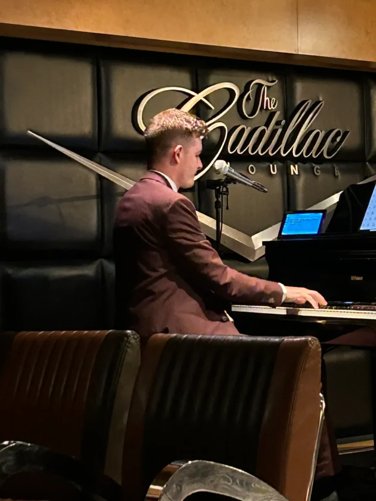 Most evenings, you can grab a cocktail and listen to music in the Cadillac Lounge and other night clubs aboard Disney Cruise ships. A live pianist performing in the sophisticated Cadillac Lounge piano bar onboard a Disney cruise for adults.