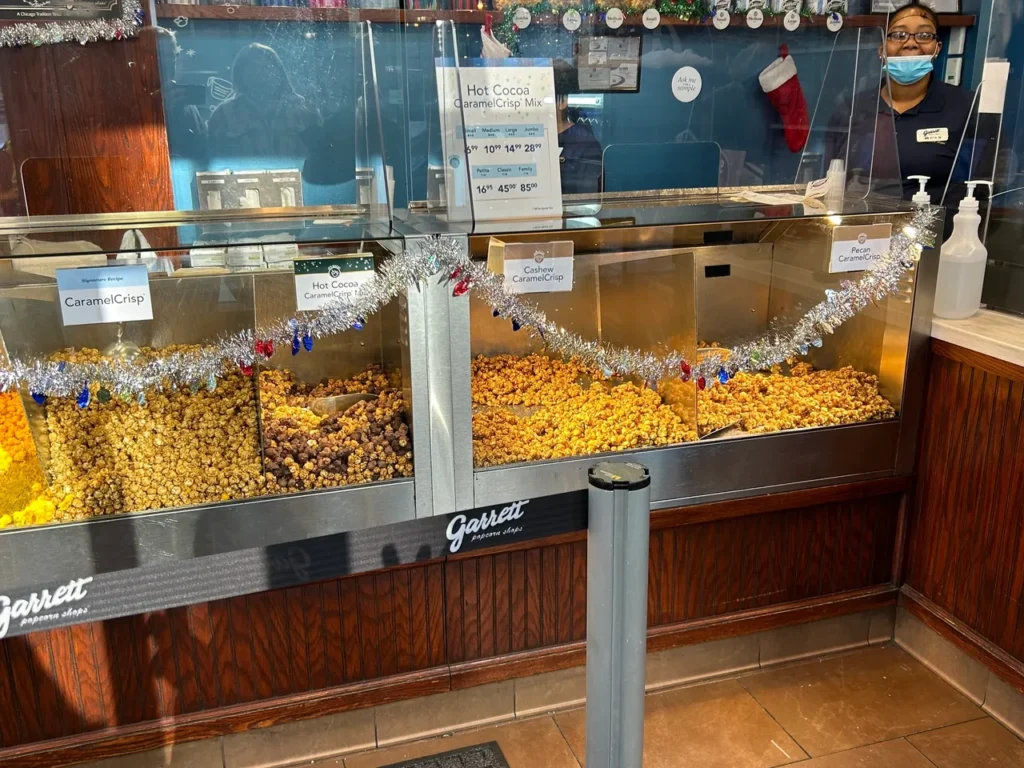 A trip to Chicago isn't complete without popcorn from one of the Garrett's Popcorn locations. You can sample the Chicago Style popcorn in a small bag or a giant gift tin, pending on the size of yor appetite. Counter display of Garrett's popcorn sampled during the Secret Food Tour Chicago.