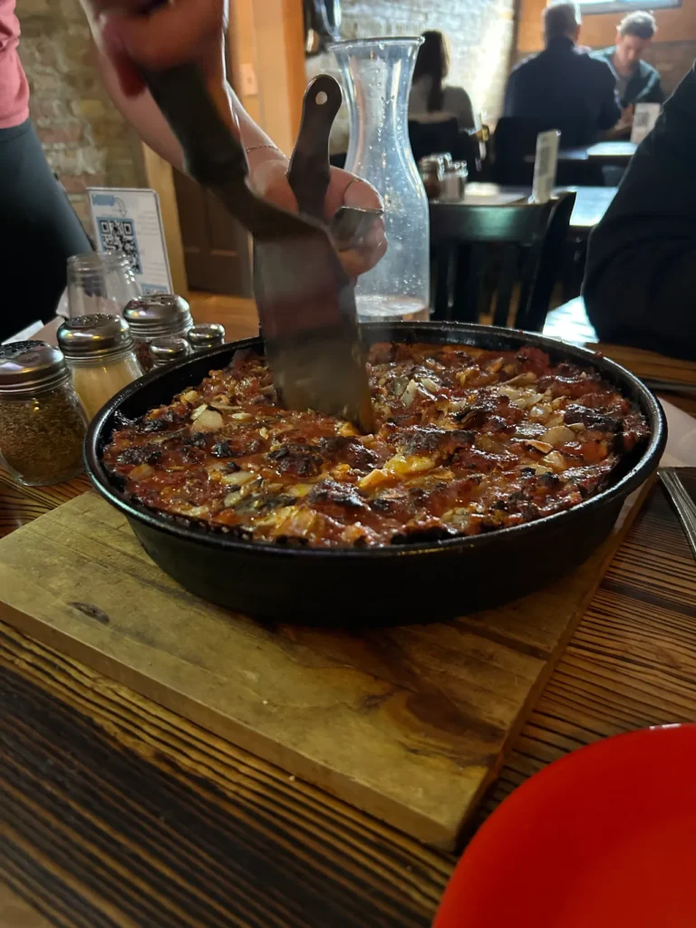 Chicago-style pizza from Pequod's Pizza in Chicago. They were recently named the top pizza restaurant in the country. A freshly baked sausage, mushroom, and garlic Chicago-style deep-dish pizza with a signature dark caramelized cheese crust at Pequod's Pizza Chicago.