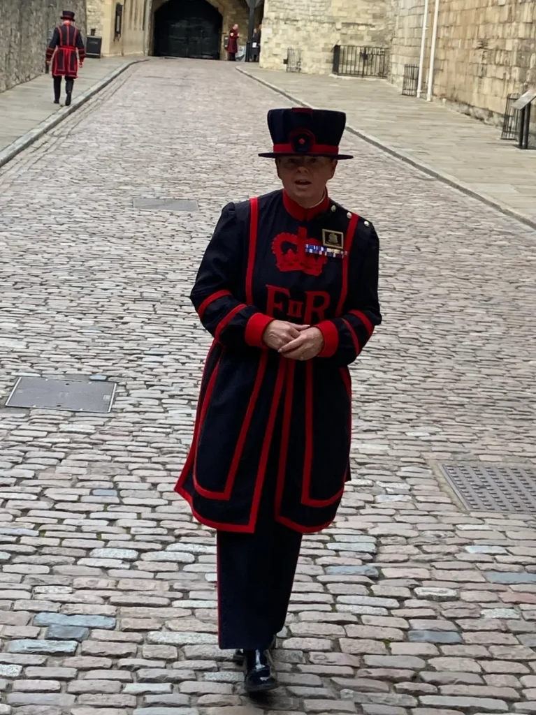 Amanda Clark, the second Yeoman Warder in history provided us a narration of the ceremony to open up the Tower of London. Amanda Clark, the second female Yeoman Warder in history, standing on the cobblestones at the Tower of London planning guide landmark.