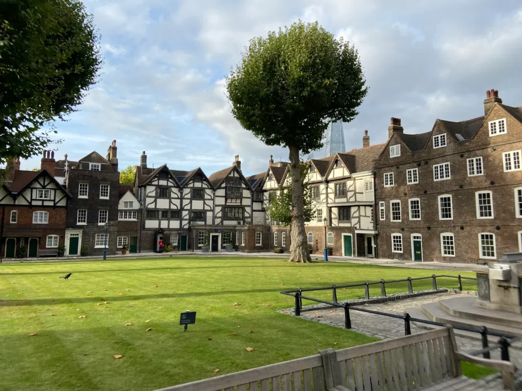 Inside the walls of the Tower of London is a lovely village green. Back in the day, this is where the crowds would gather to witness one of the many executions that took place. The lush historic village green and timber-framed houses inside the fortress walls at the Tower of London planning guide site.