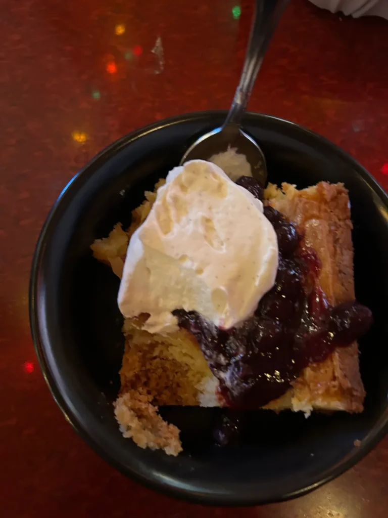The combination of a cake with a Hoosier tradition the sugar cream pie, the creation of a sugar cream cake is born. Topped with blueberries and fresh whipped cream is a sweet ending to a memorable meal at Bonge’s. A slice of house-made Hoosier sugar cream cake topped with blueberries and fresh whipped cream at Bonge's Tavern Indiana.