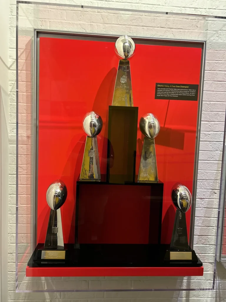 There are several great displays of the Lombardi Trophy, perfect for a photo opportunity for fans. A collection of five official Super Bowl Lombardi Trophies on display inside a glass case at the Pro Football Hall of Fame Canton.