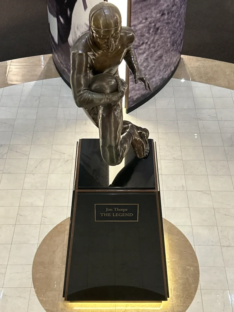 Jim Thorpe was the greatest athlete of his era. Excelling in the 1912 Olympics, he was able to transition to athletic and financial success on the gridiron, playing for the Canton, Ohio Bulldogs. The bronze statue honoring iconic athlete Jim Thorpe on display at the Pro Football Hall of Fame Canton.