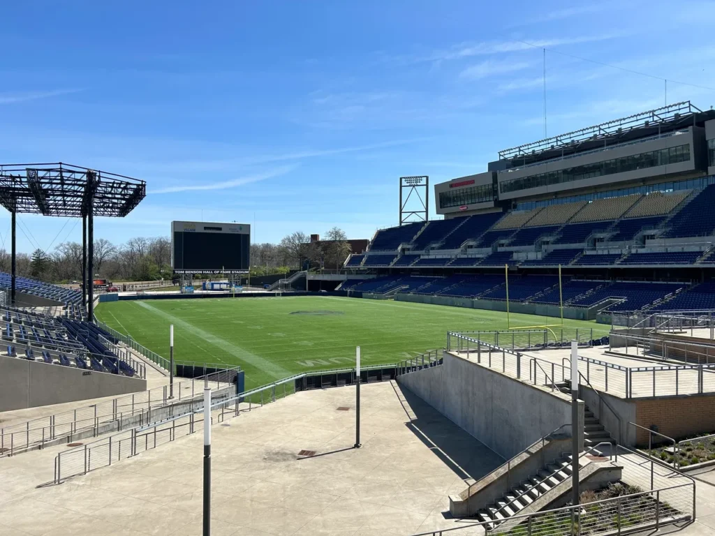 The Tom Benson Hall of Fame Stadium is a part of the museum complex in Canton. The traditional kick off to the season happens each year at this stadium with the first preseason game played. A wide view of the empty field and grandstands at Tom Benson Hall of Fame Stadium during a visit to the Pro Football Hall of Fame Canton.