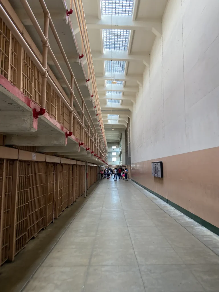 Self guided tours of the various buildings at Alcatraz will give you a glimpse of prison life. From nicer more modern cellblocks, to primitive older versions to solitary confinement, you get a picture of what life was like for residents. A high-angle interior view looking down the long, symmetrical corridor of the main cellblock at Alcatraz Prison San Francisco.