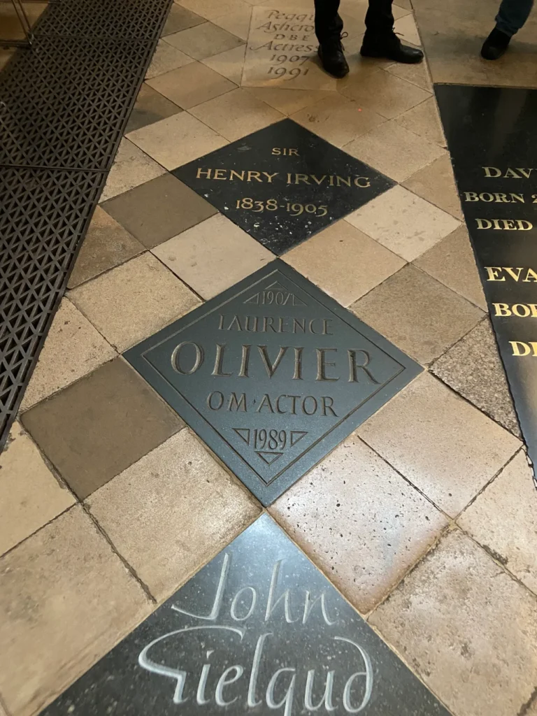 Famed actor Sir Laurence Olivier is memorialized along with other great musicians and entertainers at Westminster Abbey. The dark diamond floor grave markers of legendary actors Laurence Olivier and John Gielgud at Westminster Abbey London.