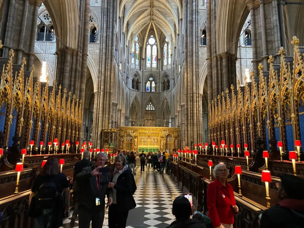 Walking through Westminster Abbey seemed familiar, because of all the times we’d seen it on TV over the years. This iconic view shows off the Quire section of The Abbey, with the worship stalls on either side. You can also see the iconic fan ceiling above. A view looking down the central aisle of the ornate Quire section and choir stalls at Westminster Abbey London.