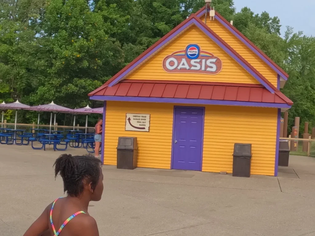 Oasis stations are available throughout Holiday World and Splashin Safari, where you can go and fill up on your favorite soft drinks at no charge. A bright yellow and orange Pepsi Oasis free soft drinks station inside Holiday World Santa Claus Indiana.