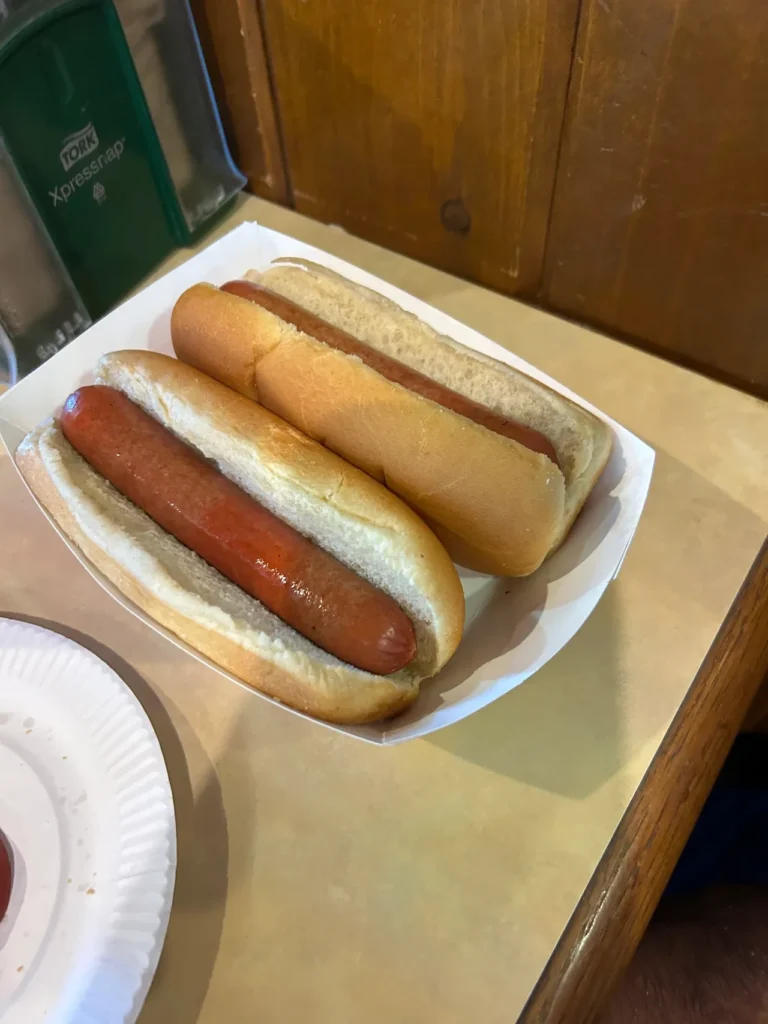 Known for their hamburgers, Redamak's also serves up a savory two hot dog meal that will hit the spot. A savory two hot dog meal served in a paper boat at Redamak’s Michigan.