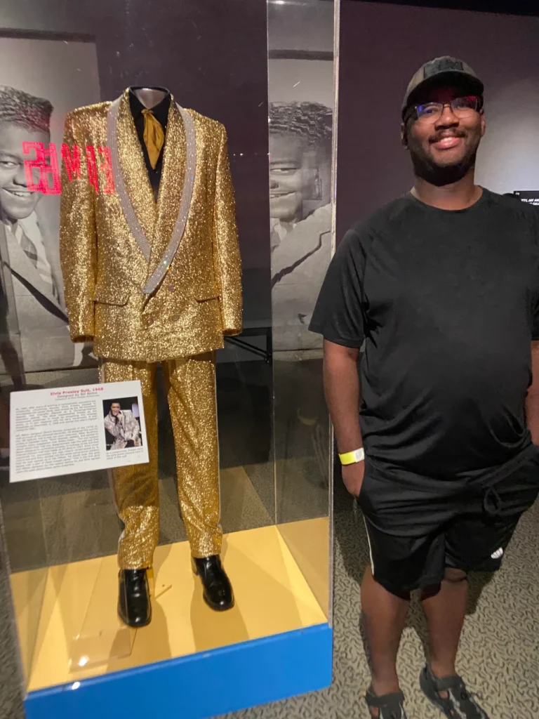 The influence of Elvis Presley can be seen through the hall of fame. On display here, Elvis's gold suit from 1968. Elvis Presley's iconic 1968 gold tuxedo suit on display inside a museum showcase at the Rock and Roll Hall of Fame Cleveland.