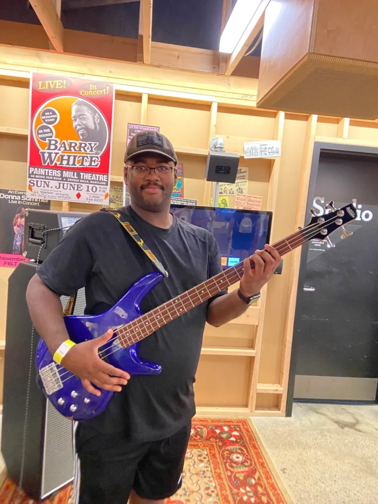 Spend some time on the second floor of the Rock Hall pretending to be in a garage band. The Garage exhibit gives you some great photo opportunities. A visitor playing a blue electric bass guitar inside The Garage exhibit at the Rock and Roll Hall of Fame Cleveland.