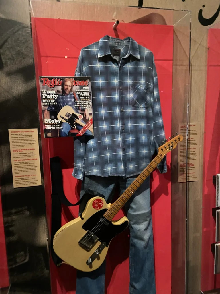 Tom Petty display at the Rock and Roll Hall of Fame. This features one of his guitars along with the outfit he wore for the cover of Rolling Stone magazine. Tom Petty's stage-worn flannel outfit and custom electric guitar on display at the Rock and Roll Hall of Fame Cleveland.