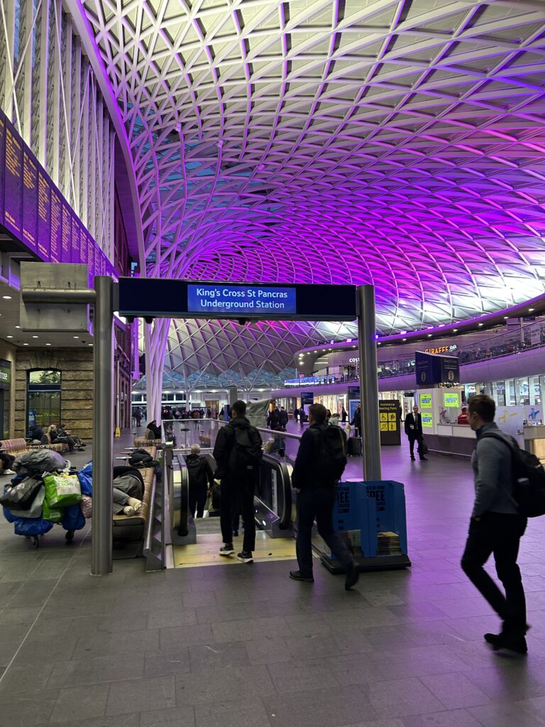 King’s Cross Station, located in the heart of London is probably best known for its part in Harry Potter. It is also a bustling transportation hub, including for service from London to Edinburgh. The stunning modern purple-lit vaulted roof architecture over the concourse inside King's Cross Station, a key stop on our LNER first class London to Edinburgh rail journey.
