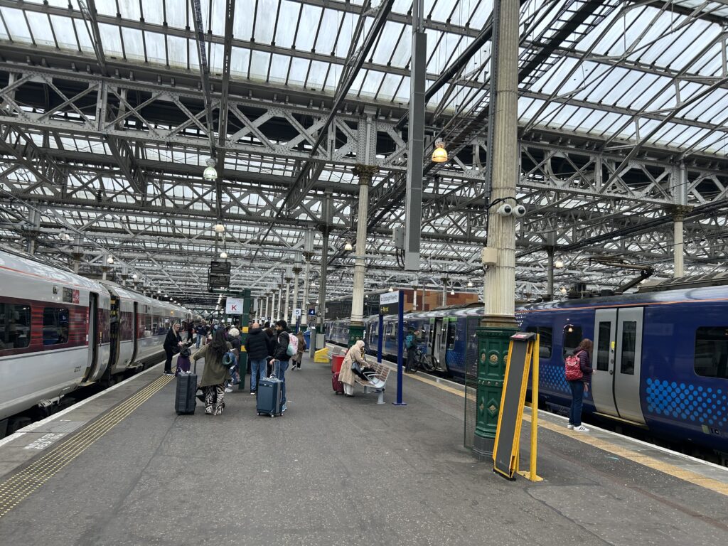 The LNER train from London to Edinburgh’s final destination is Waverly Station, just off downtown. An LNER train sitting at the busy arrival platform inside Edinburgh's Waverley Station, the final destination of our LNER first class London to Edinburgh rail review.