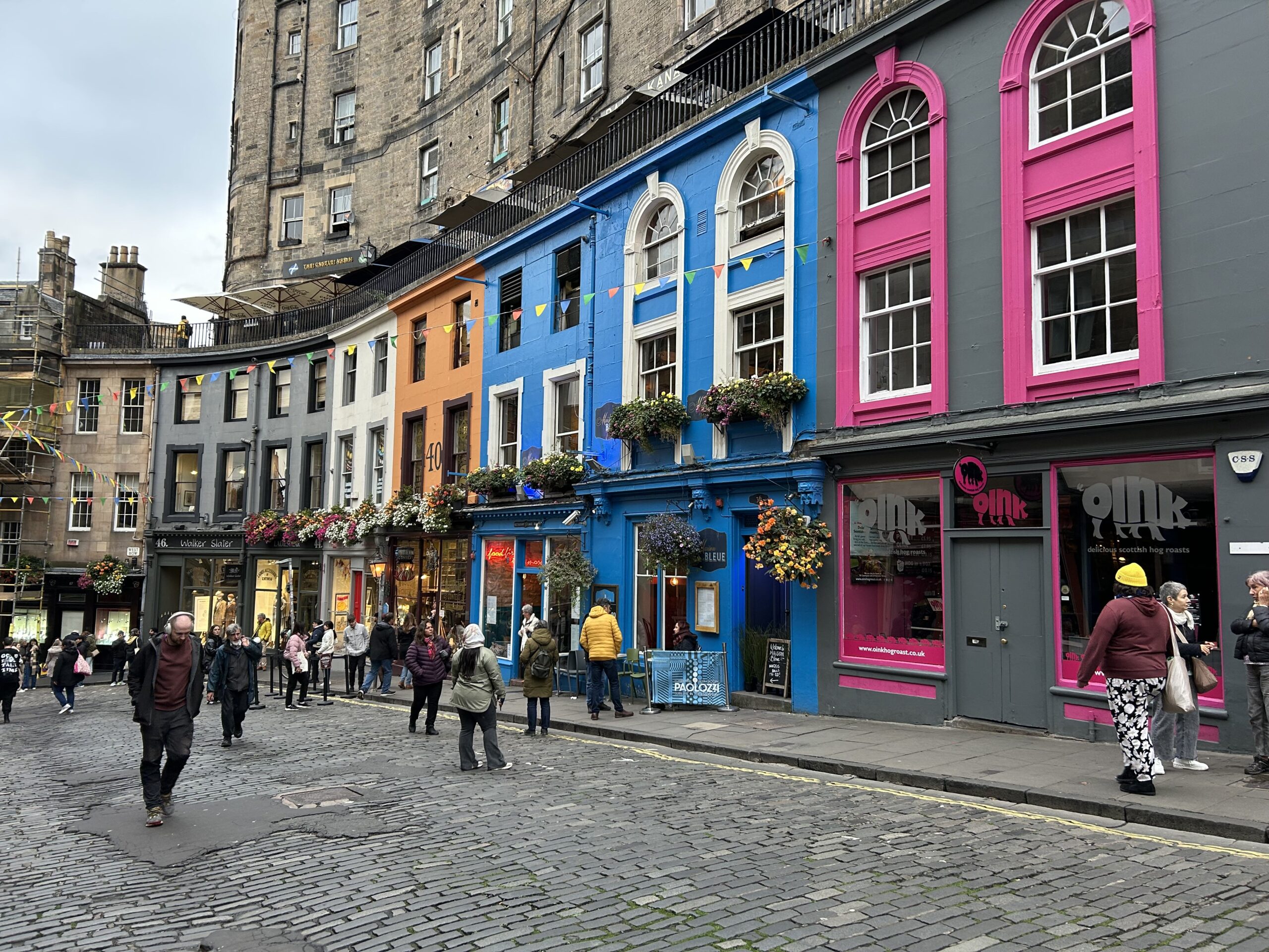 The colorful storefronts of historic Victoria Street, the inspiration for Diagon Alley, featured in our Harry Potter walking tour Edinburgh travel guide.