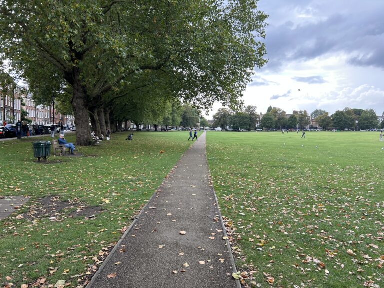 The expansive green grass and walking paths of the historic Richmond Green park, featured in our Richmond England Ted Lasso walking guide.
