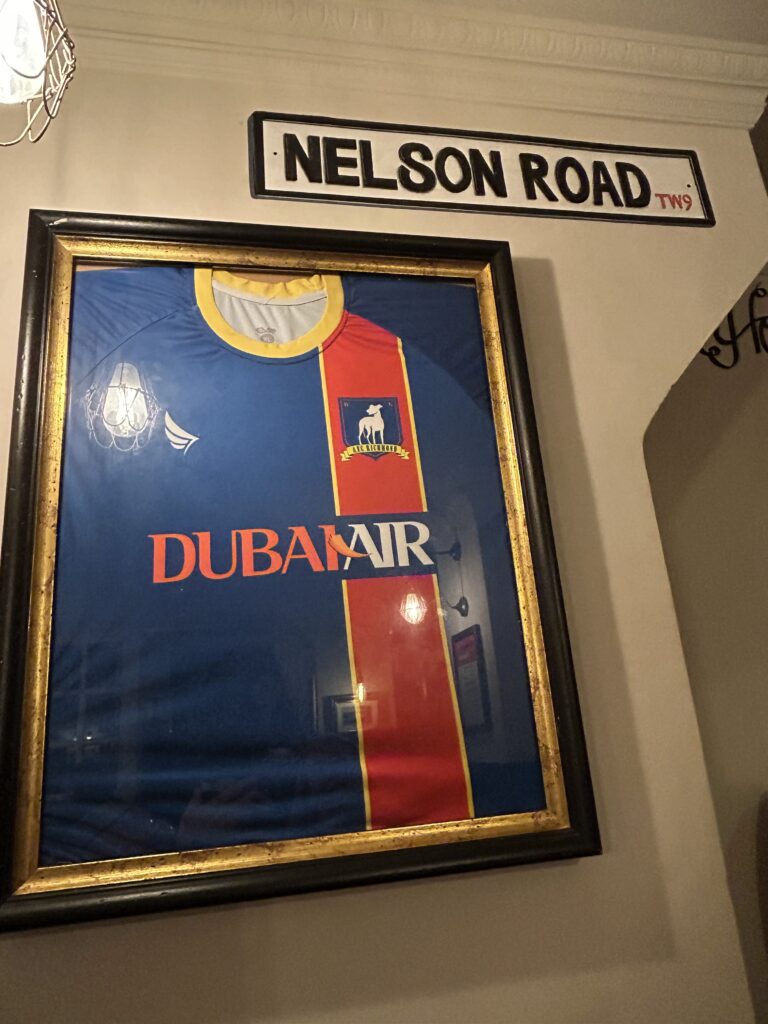We never came across a Nelson Road in Richmond, which is the fictional home of AFC Richmond's football team. A cozy corner booth filled with AFC Richmond team gear and photos, a highlight of the real Ted Lasso pub in Richmond.