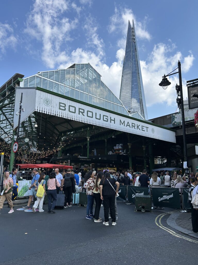 The iconic green art deco entrance glass facade of London's Borough Market, a top food destination in England.