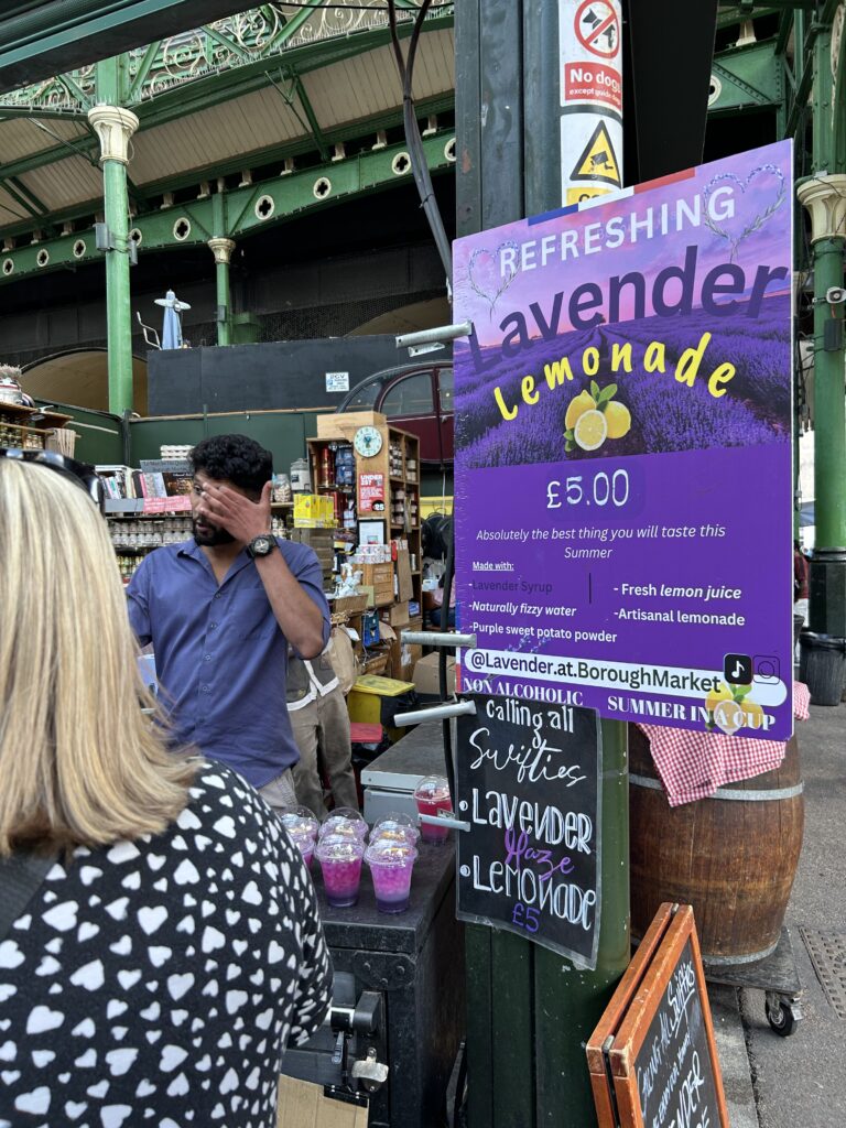 Lavender lemonade for sale at Borough Market, London A vibrant purple lavender lemonade menu sign on display at a vendor stand inside London's Borough Market, a top food destination.