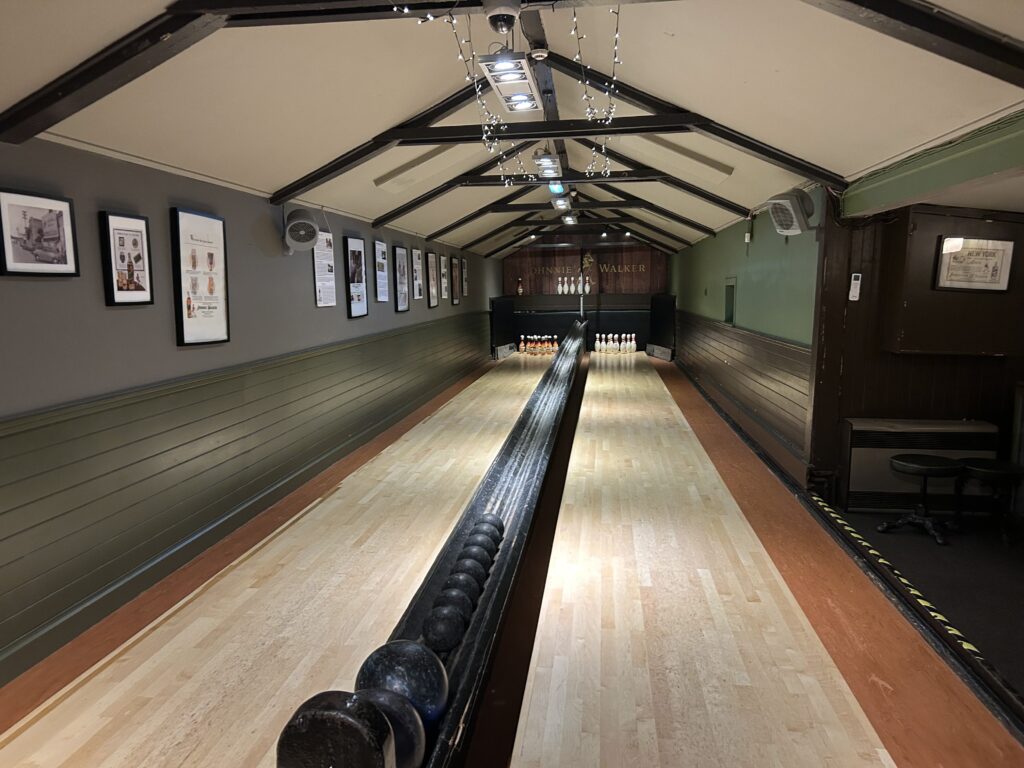 You can reserve two skittle alleys for your group at the Sheep Heid Inn. Built in the mid 1800s, you have to hand set the pins and drop the ball into the return after each frame. The historic interior of the working antique skittle alley at The Sheep Heid Inn Edinburgh, featuring traditional hand-set bowling lanes.