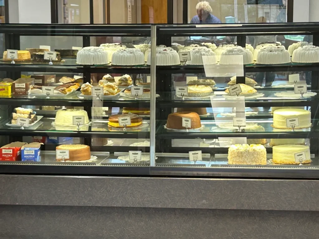 Dessert case at Shapiro’s Deli in Indianapolis A glass display bakery case filled with fresh cakes, cheesecakes, and pastries at Shapiro's Deli Indianapolis.