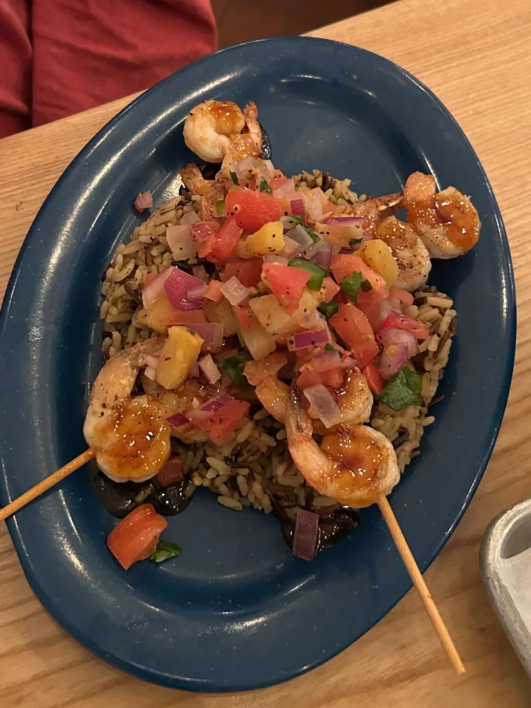 Blackened shrimp skewers from Beachcomber's Restaurant in St. Augustine, Florida Flavorful blackened shrimp skewers topped with pineapple pico de gallo over rice at Beachcomber's Restaurant, a highlight of our St. Augustine restaurants guide.