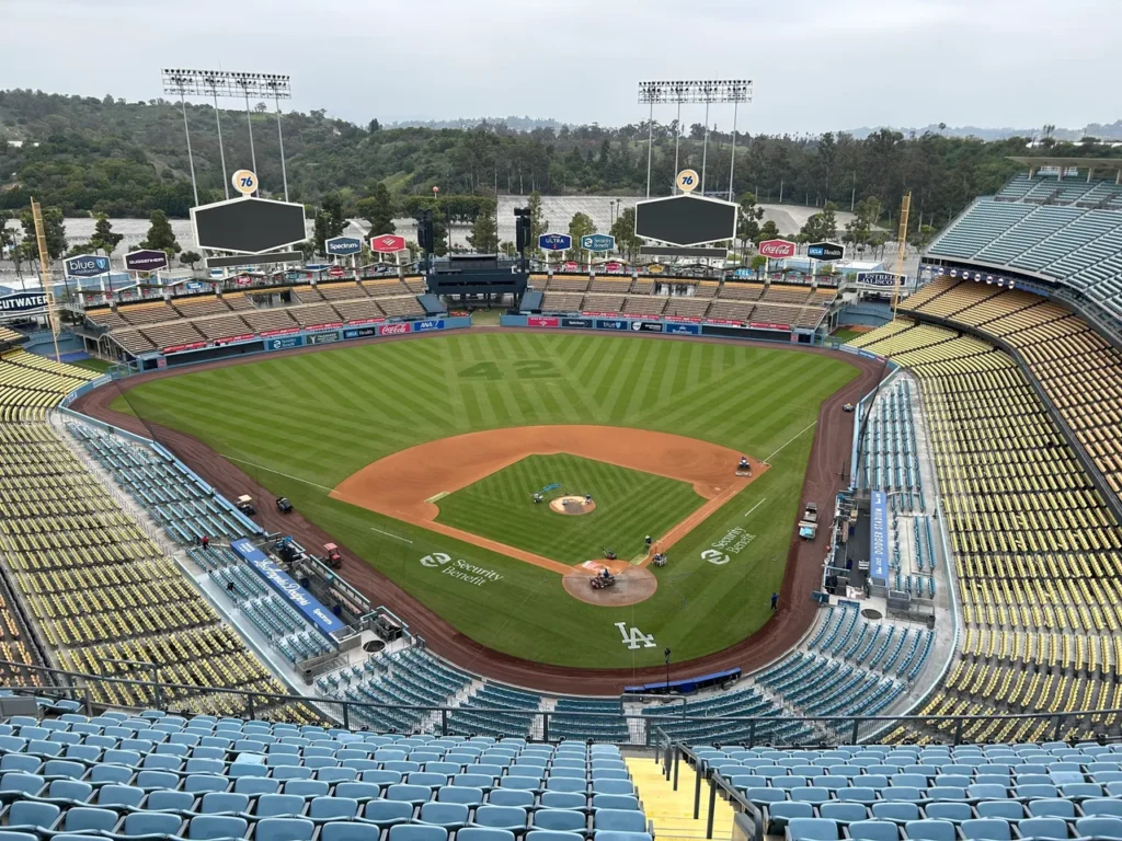 This is the view from media row at Dodger Stadium. A spectacular panoramic view of the playing field and empty grandstands taken from media row, showcasing a classic angle of Dodger Stadium baseball history.