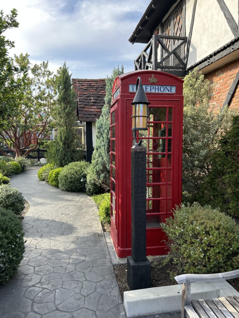 The lovely decor extends to the outside areas at Tam O'Shanter too. The Scottish pub feel extends to the outdoor dining area, a perfect way to enjoy the weather of Southern California. A classic red telephone booth alongside a stone-paved garden walkway in the outdoor patio area at the Tam O'Shanter Inn Los Angeles.