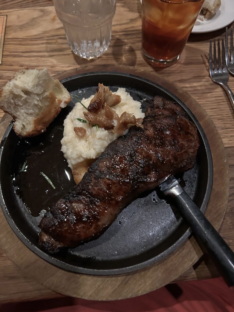 Come hungry at Tam O'Shanter because their big cuts of steak will fill you up. That includes the New York strip steak, 14 oz. and served with mashed potatoes and garlic confit. A 14-ounce New York strip steak served with mashed potatoes, gravy, and garlic confit at the Tam O'Shanter Inn Los Angeles.