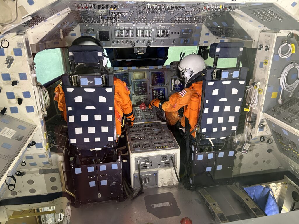 The museum features a space shuttle exhibit, including an opportunity to see what it’s like in the cockpit. The interior cockpit area and crew compartment trainer inside the space shuttle exhibit, highlighting a unique stop for Dayton Ohio aviation history.