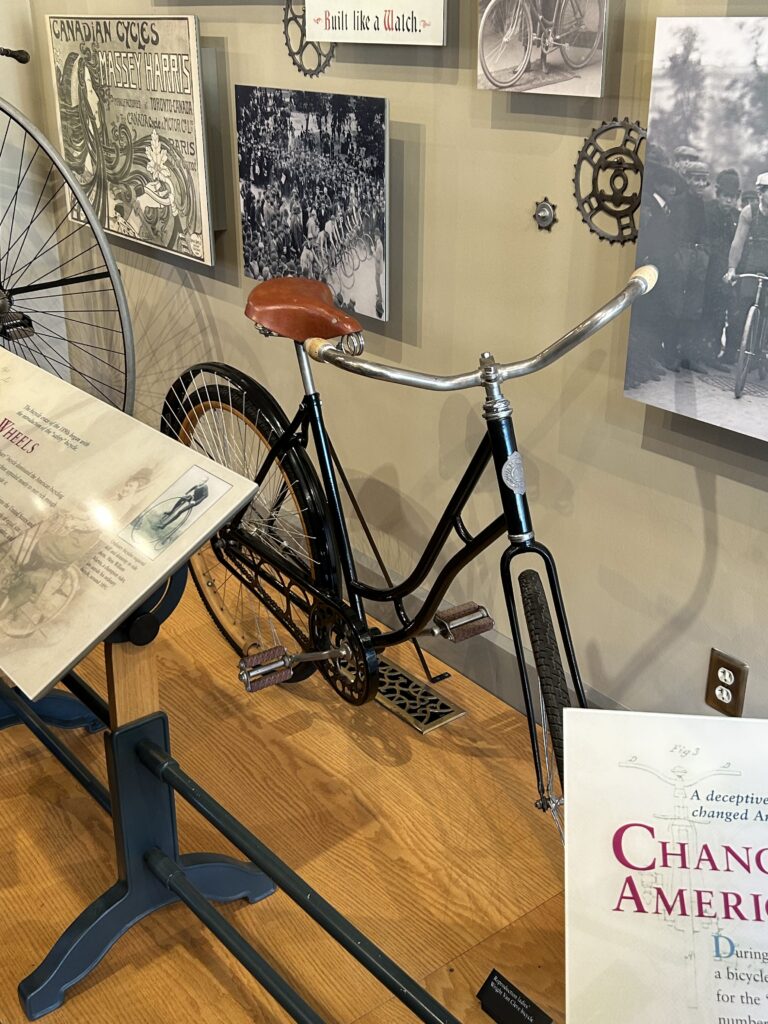 On display at the cycle shop run by the Wright Brothers is some of their equipment, as well as some of their original creation like this bicycle. An original Wright Brothers bicycle display with a leather seat and black frame, a major highlight of Dayton Ohio aviation history.