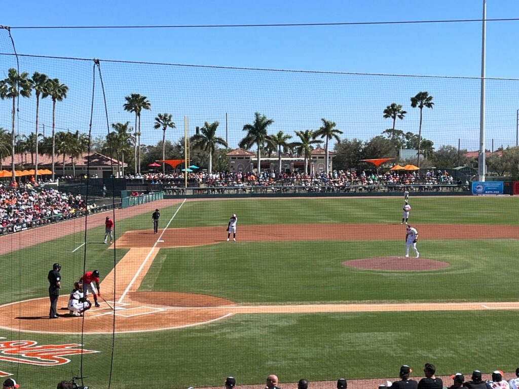 Ed Smith Stadium in Sarasota is the home of the Baltimore Orioles, and a great place to soak in the sun and catch a few innings of baseball. A sunny daytime view of the baseball field and palm trees at Ed Smith Stadium during a Florida spring training guide tour.