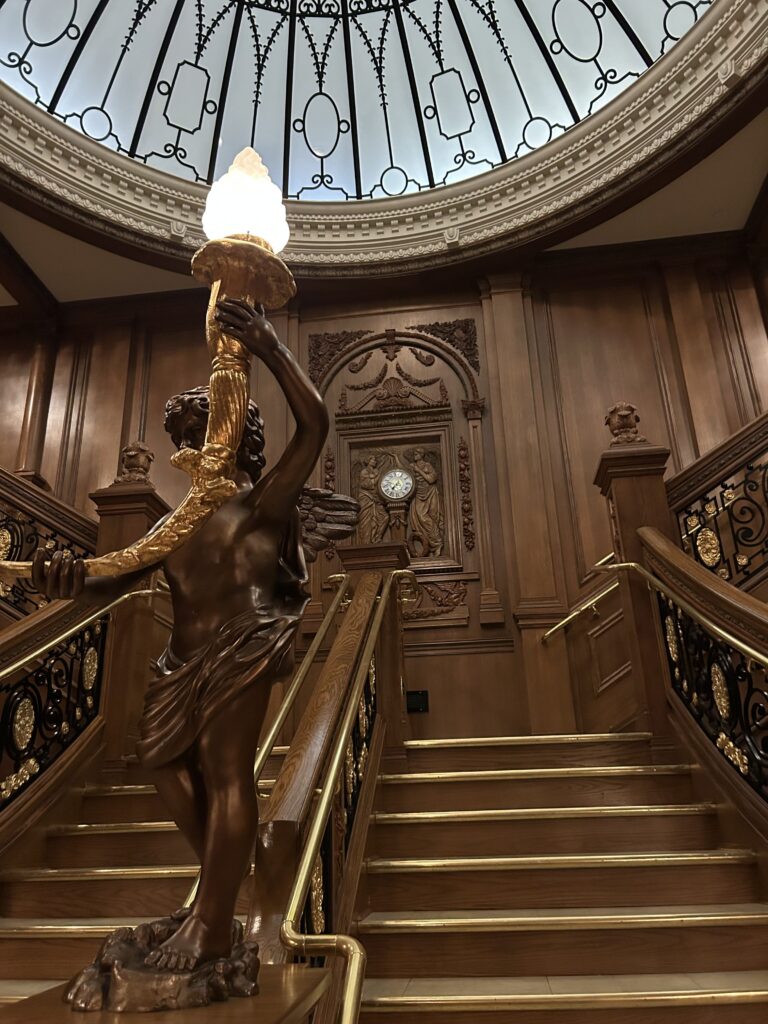 Visitors can get their photo and walk down a replica of the grand staircase from Titanic. This is an exact recreation, built from the original plans from ship builder Harland & Wolff. The stunning, million-dollar recreation of the Titanic grand staircase featuring intricate oak carvings and a bronze cherub statue at the Titanic Museum Pigeon Forge.