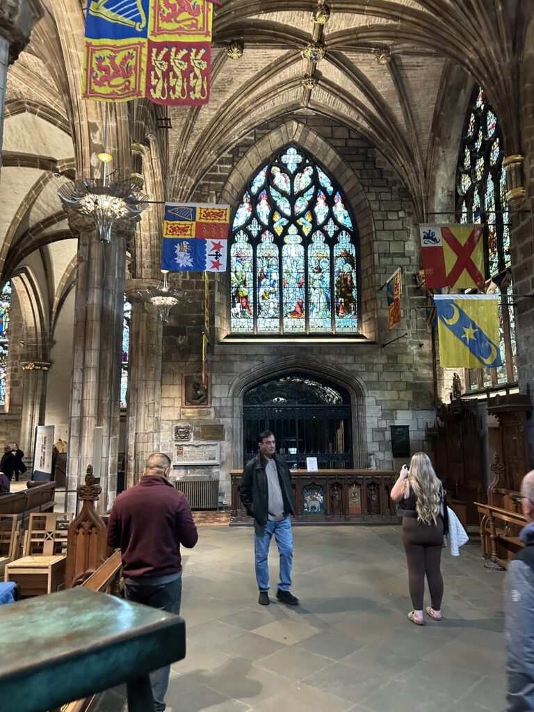 The stunning historic architecture and detailed stained glass inside St. Giles Cathedral on the Royal Mile for an Edinburgh travel guide.