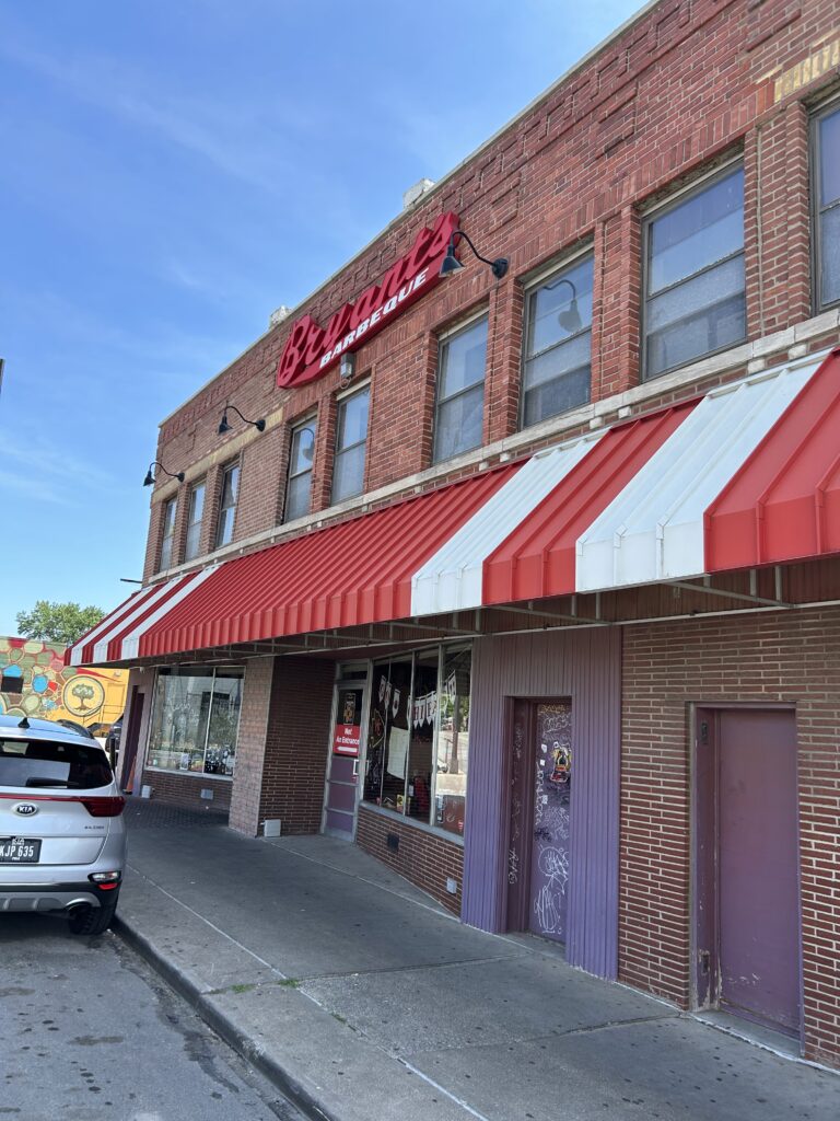 Located at 18th and Brooklyn, Arthur Bryant's Barbeque is a Kansas City institution. The iconic brick exterior and historic street sign of Arthur Bryant's Barbeque on Brooklyn Avenue during a Kansas City BBQ tour.