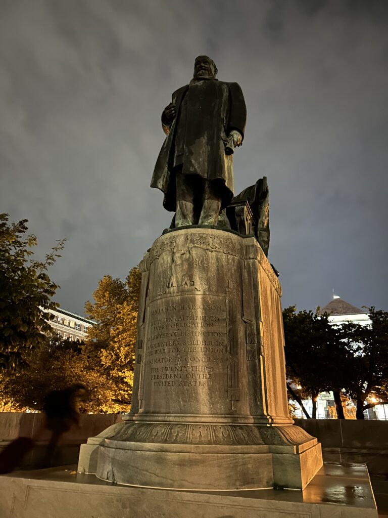 The curse of the Harrisons is explained in detail. This is a statue of former President Benjamin Harrison. Both Benjamin and his grandfather, former president William Henry Harrison died of pneumonia. W. H. Harrison died in office after serving only 30 days. The bronze statue of President Benjamin Harrison at dusk during a haunted Indy walking tour.
