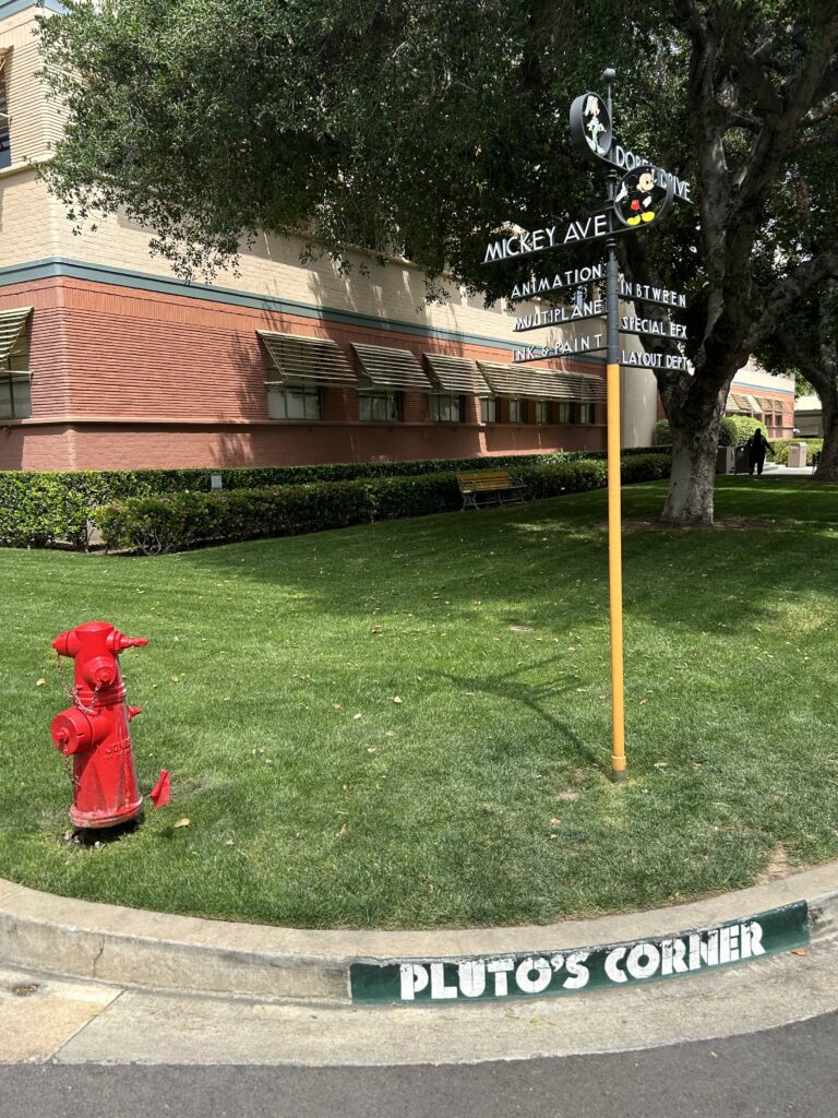Pluto's Corner on the Disney Studio lot is located just outside the Animation Building. The iconic historic crossroads signpost marking Mickey Ave and Dopey Drive at the lot during a Walt Disney Studios tour in California.