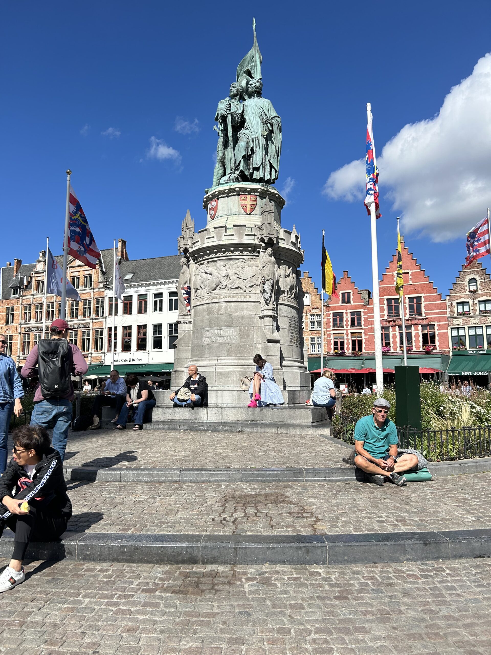 The bustling historic Markt Square and iconic Belfry tower during a Bruges day trip.
