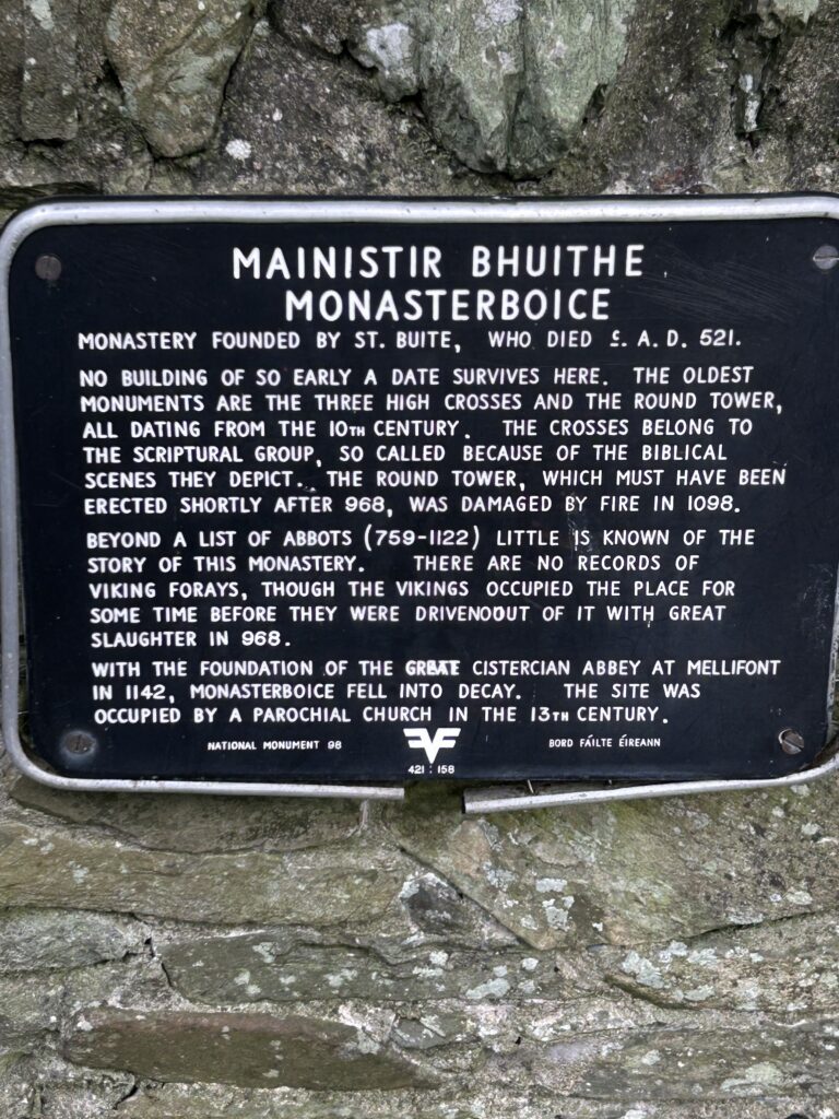 Historic marker for Monasterboice The historic black metal entrance plaque detailing the founding and heritage of the site during a Monasterboice day trip Dublin.