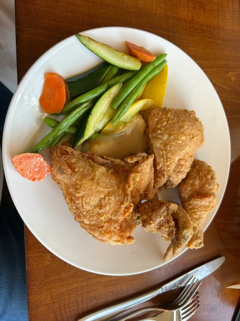 Golden Lamb has received many awards over the years. Their most decorated dish is the pan-fried chicken dinner. A crisp, golden-brown pan-fried chicken dinner served with mashed potatoes, gravy, and green beans at The Golden Lamb restaurant in Ohio.