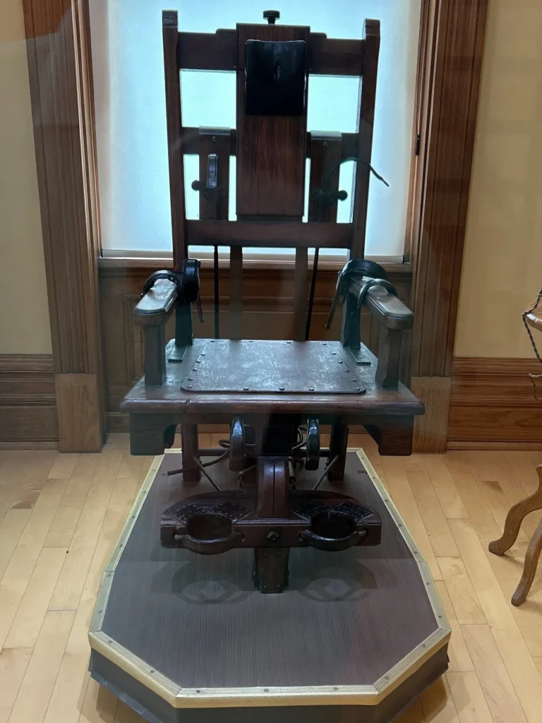 The centerpiece of the Old Sparky: Capital Punishment in Ohio tour is the infamous electric chair used by the state for over 60 years. While never used for executions at the Mansfield Reformatory, this artifact is on loan to provide a sobering look at the history of justice in Ohio. The exhibit details the lives of the 315 individuals who met their end in this chair at the Ohio State Penitentiary in Columbus. The historic Old Sparky electric chair museum display inside the Ohio State Reformatory on a Shawshank Redemption prison tour.