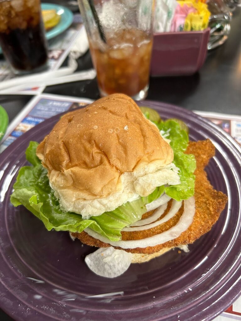 The breaded pork tenderloin sandwich originated at the legendary diner Nick’s Kitchen in downtown Huntington, Indiana. They offer the full-sized sandwich and this is mini version.