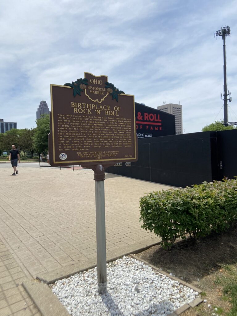 The brown Ohio Historical Marker for the Birthplace of Rock N Roll outside the Rock and Roll Hall of Fame in Cleveland, Ohio.